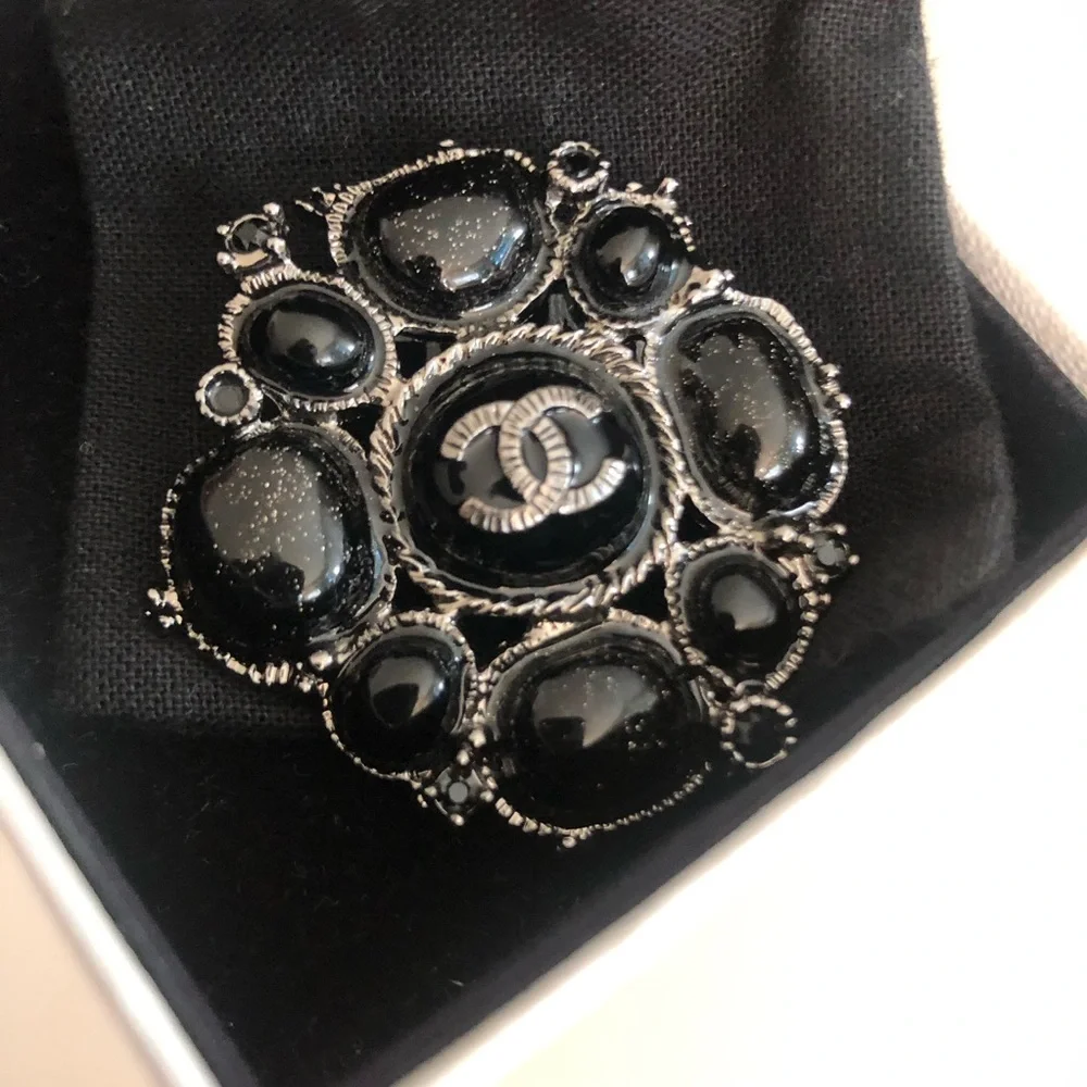 CHANEL Black Camellia Brooch - Signature Logo Accent